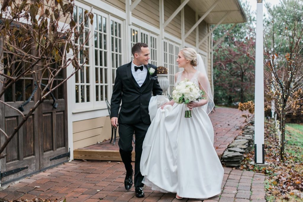 Bride and groom walking down brick path at the Inn at Leola Village by the Jepsons