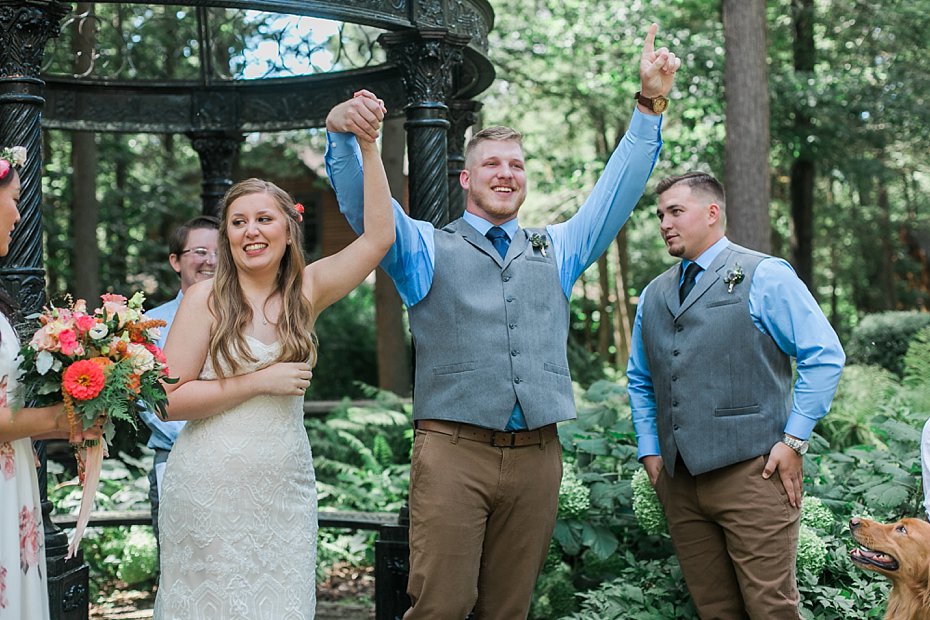 Groom celebrates at alter in outdoor wedding