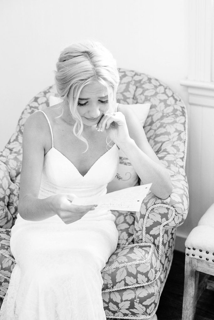 bride tears up while reading note from groom at their White Chimneys wedding