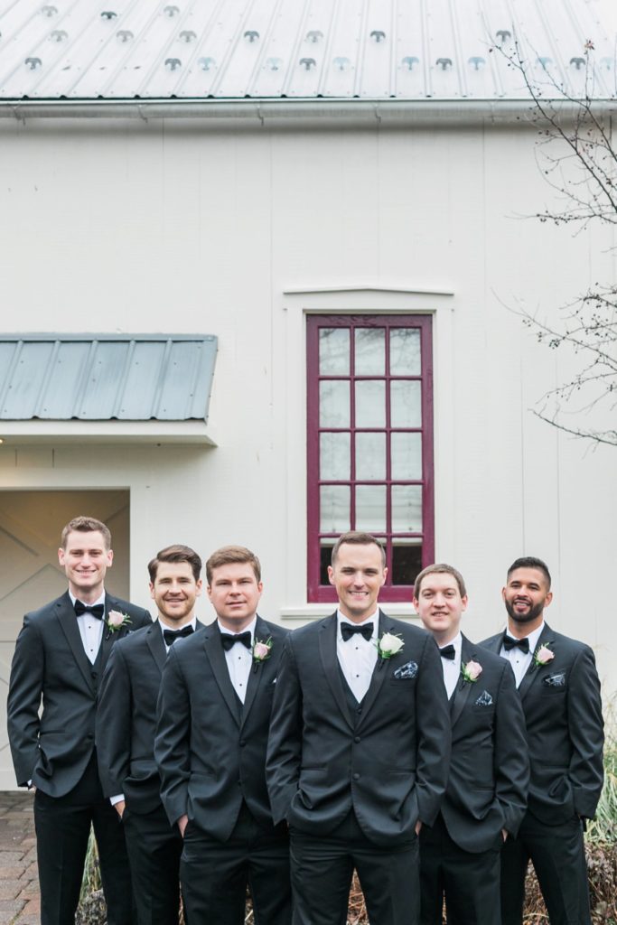 Groomsmen smiling at the Inn at Leola Village by the Jepsons