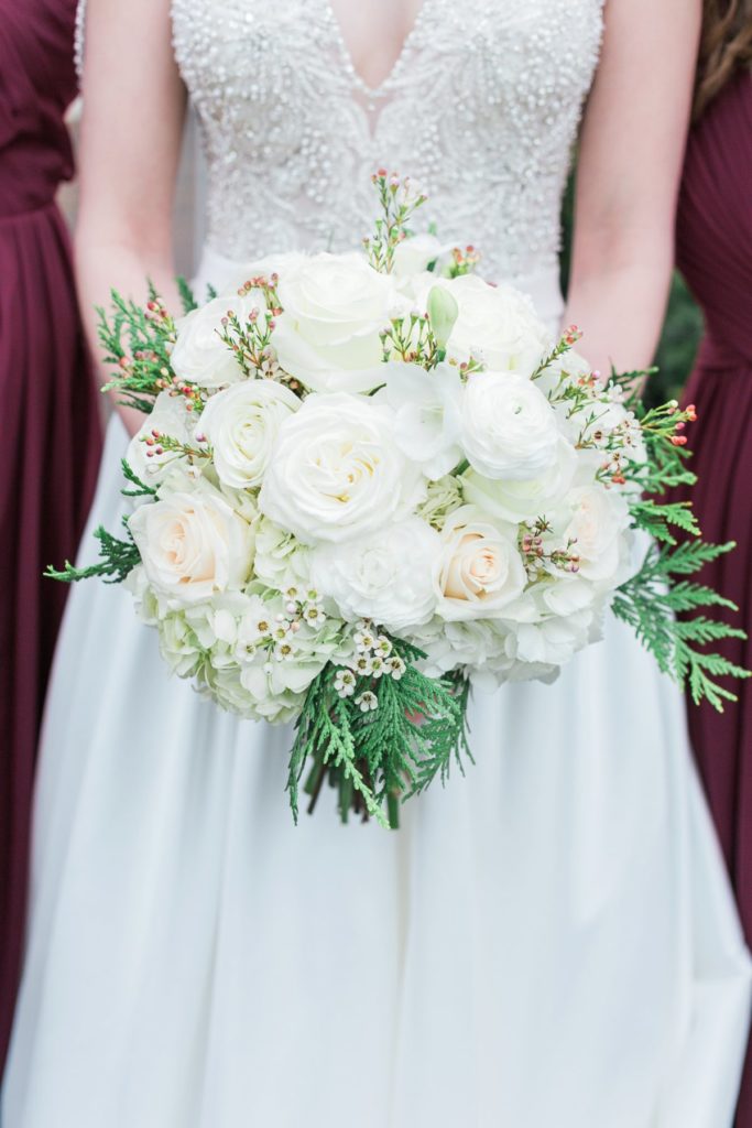 Bride holding white florals at the Inn at Leola Village by the Jepsons