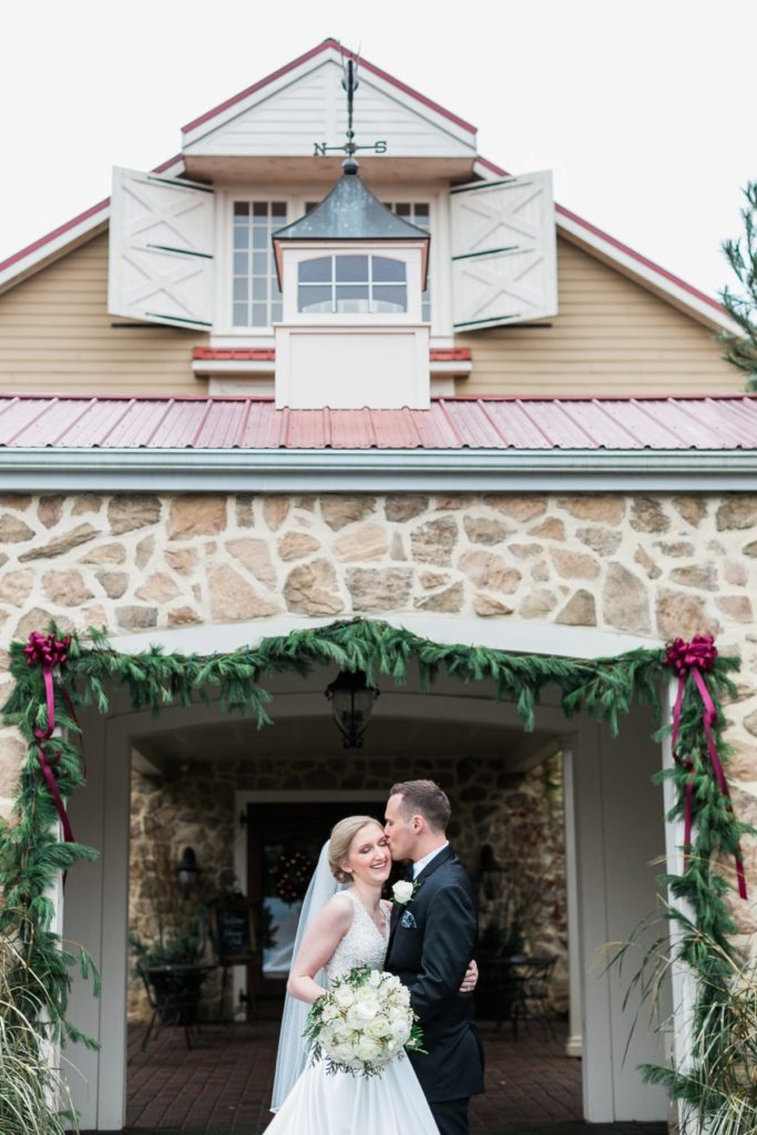 Bride and groom in front of Casa di Fiori at wedding venue the Inn at Leola Village by the Jepsons