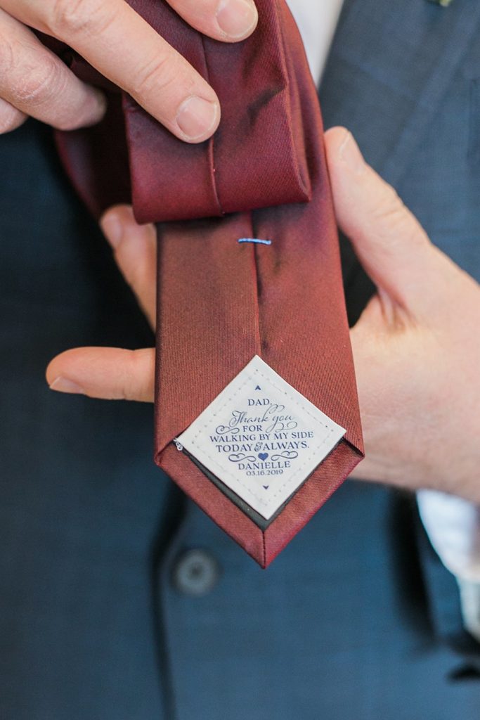 note to father from bride sewn into burgundy tie by the Jepsons