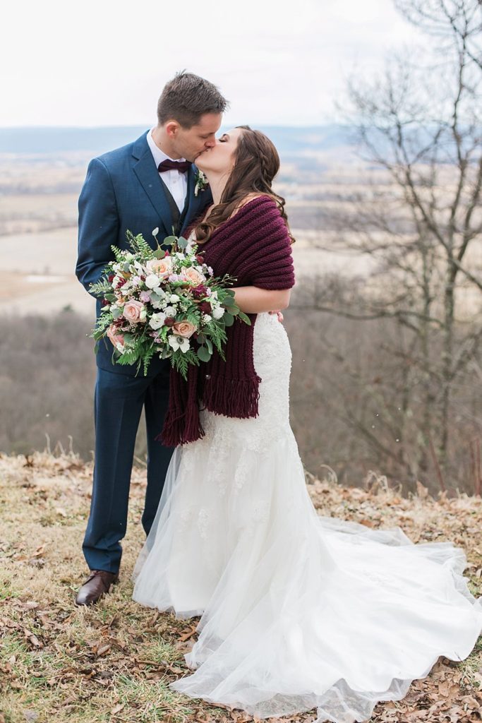 bride and groom kissing in front of view at Above the Valley in PA by the Jepsons