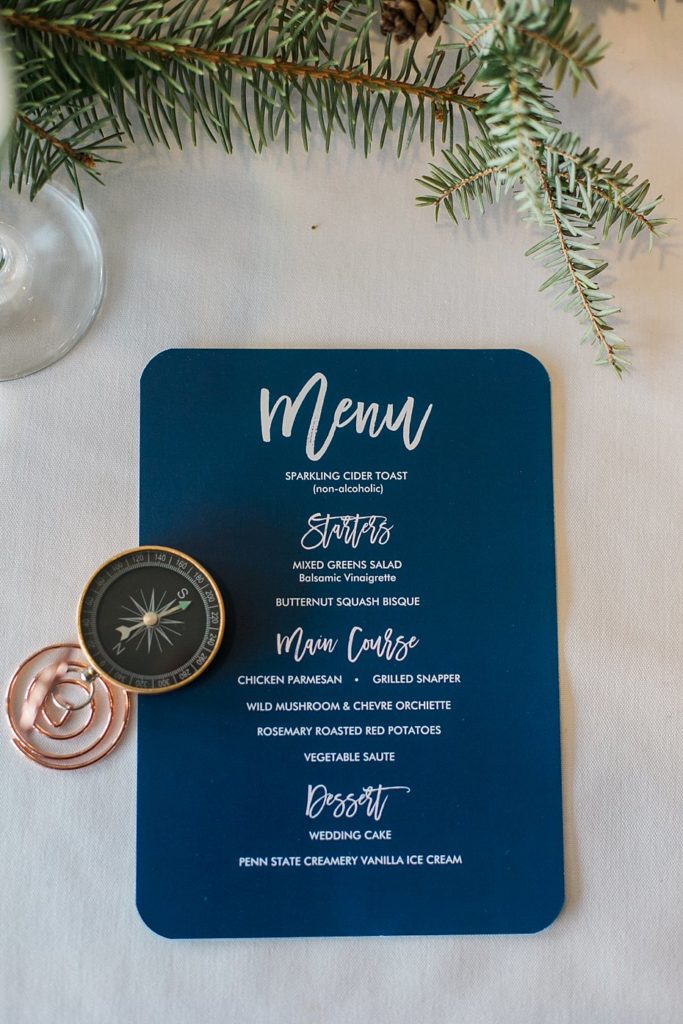 blue and white wedding reception menu card with compass detail by the Jepsons