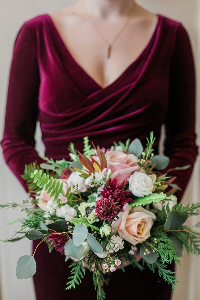 burgundy velvet bridesmaid dress with pink green and white bouquet by Pocketful of Posies photo by the Jepsons