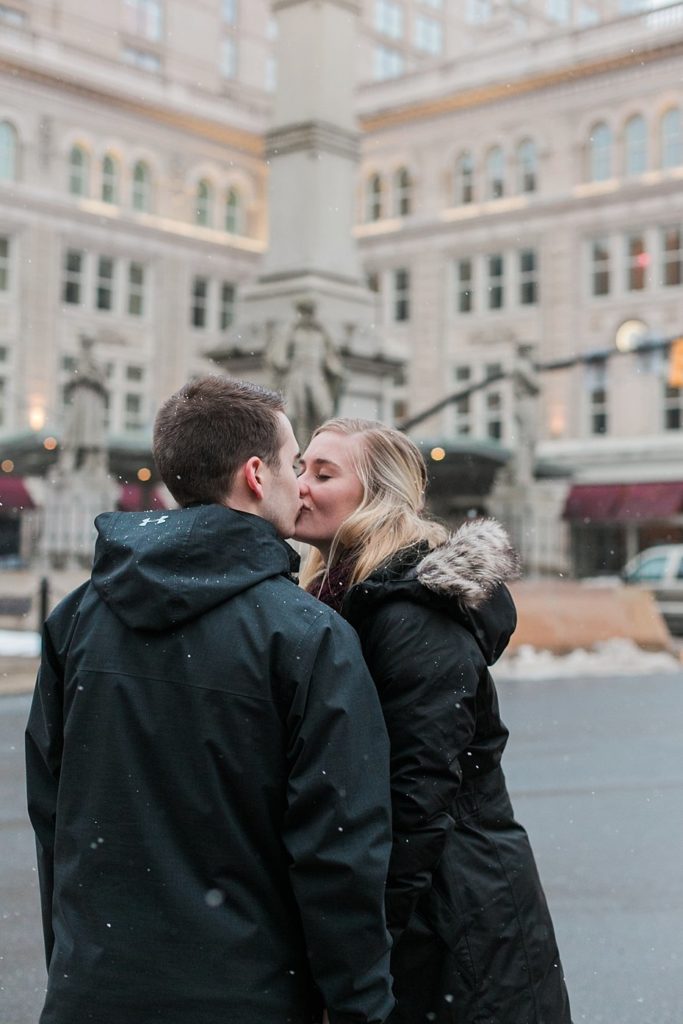 engaged couple kisses at Penn Square in Lancaster PA by the Jepsons