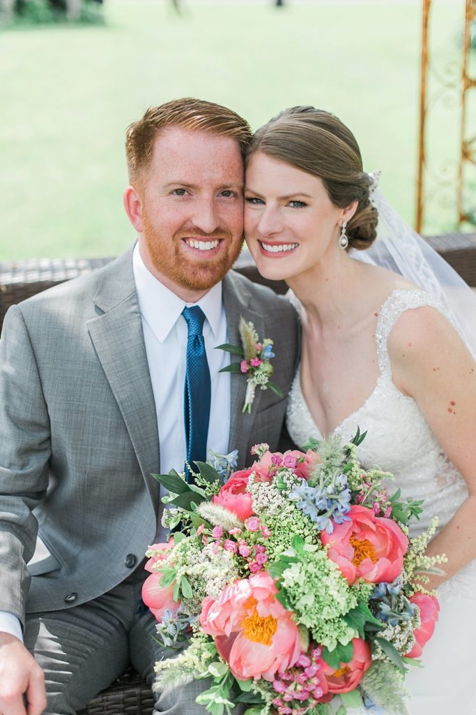 Bride and groom with coral peony bouquet made by Pocketful of Posies