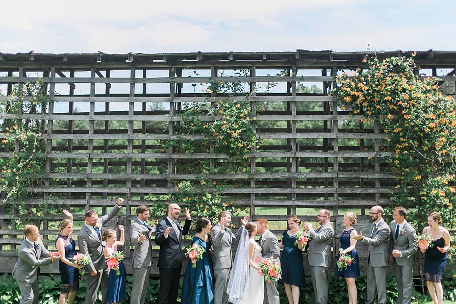 Bridal party celebrates in front of corn crib at Gillbrook Farms in Warriors Mark PA