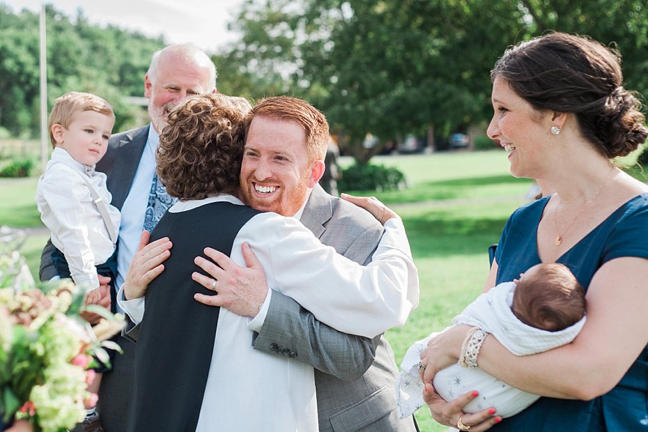 Groom hugs the officiant at Gillbrook Farms wedding ceremony