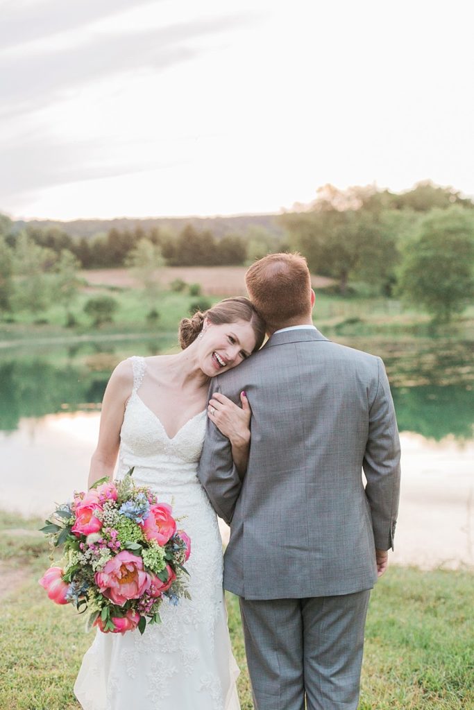 Bride and groom pose by the pond at Gillbrook Farms in Central PA by the Jepsons