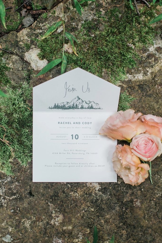 wedding invitation with flowers and moss