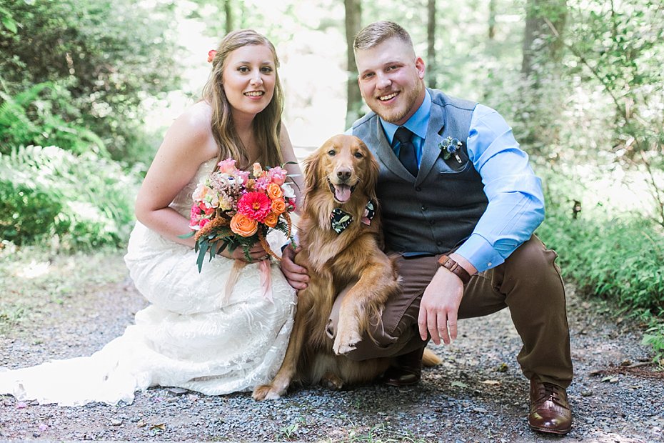 bride and groom pose for picture with their dog at Fern Hill Weddings