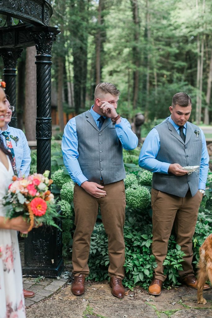 groom wipes away tears standing at alter at Fern Hill Weddings