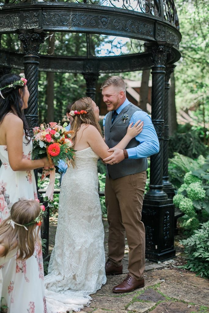 bridal couple sharing smiles after first kiss