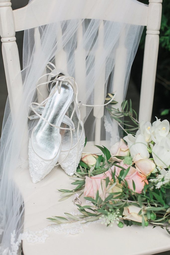 veil shoes and bridal bouquet on white chair at White Chimneys wedding