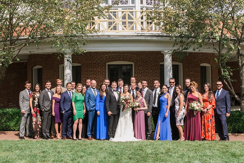 Bride and groom pose with friends outside rotunda at Omni Bedford Springs