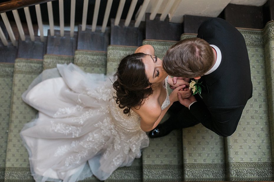 Bride and groom kiss on stairway at Omni Bedford Springs by the Jepsons