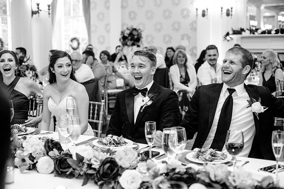 Bride and groom laugh with friends during speeches at Omni Bedford Springs by the Jepsons