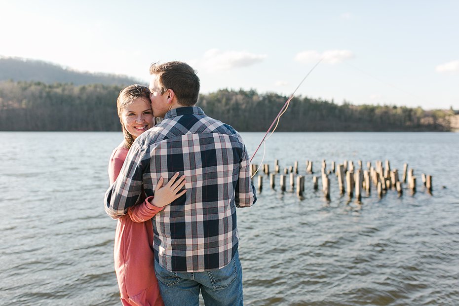 Couple fishing off pier during Colyer Lake, PA engagement session
