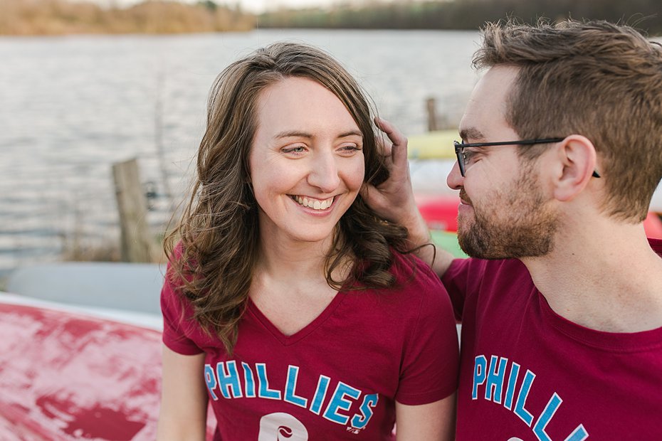 Couple sitting on canoe for engagement session at Speedwell Forge Lake in PA.