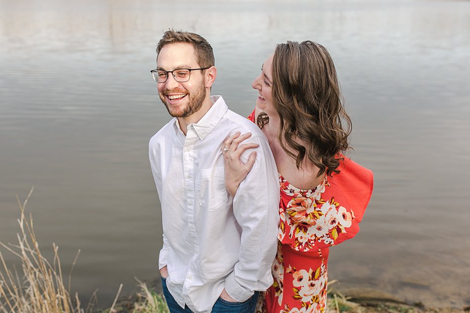 Couple laughing by Speedwell Forge Lake during engagement session by the Jepsons.