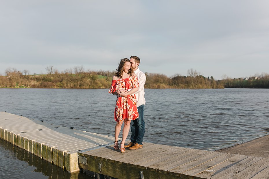 Couple poses on dock for engagement session at Speedwell Forge Lake by the Jepsons.