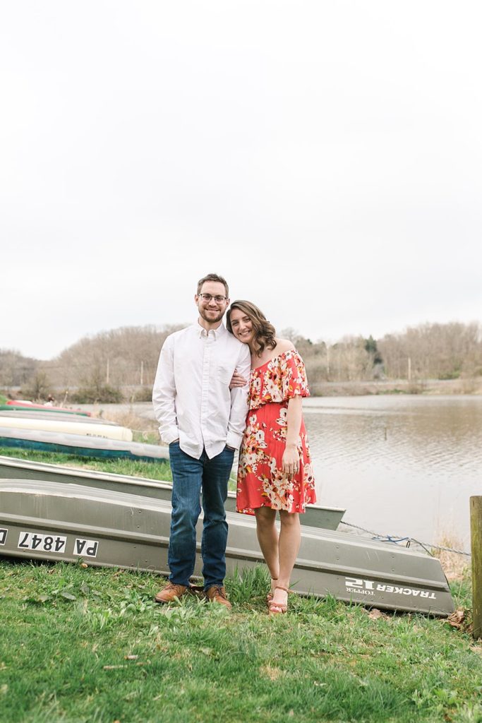Couple poses by Speedwell Forge Lake boat launch for engagement session.