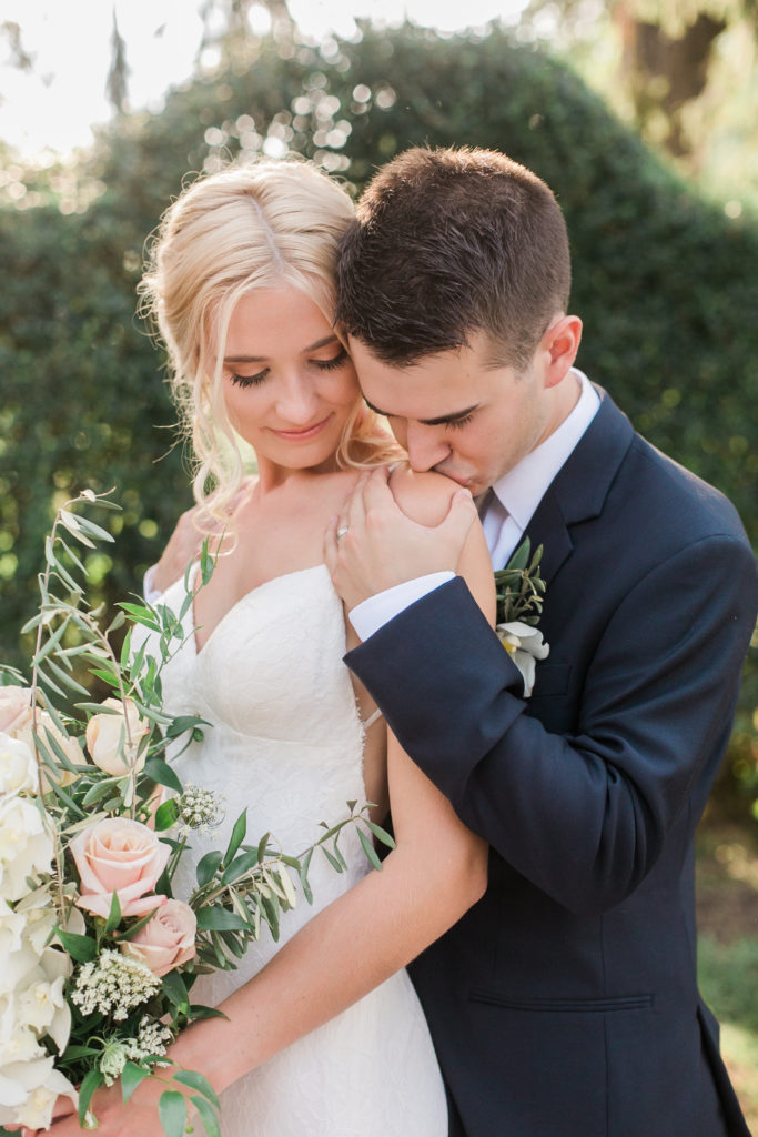 Groom kissing bride's shoulder at White Chimneys wedding in Gap Pennsylvania.