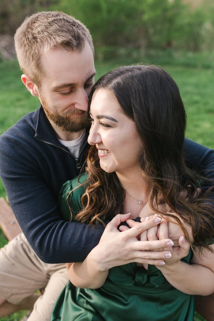 Engaged couple cuddling during engagement photo shoot in State College, PA